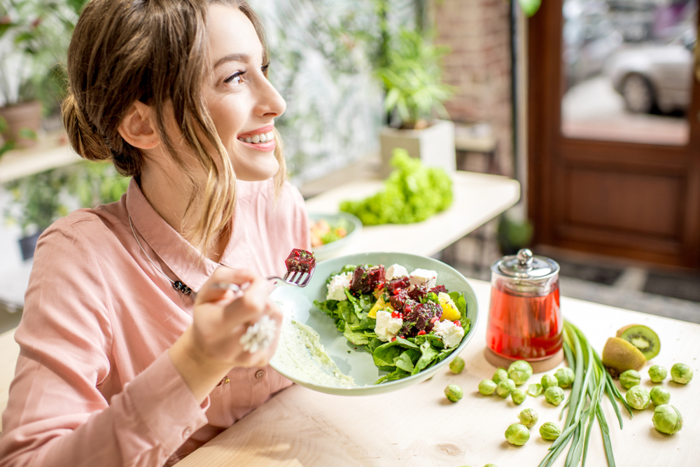 Girl Holding a Green Salad Plate